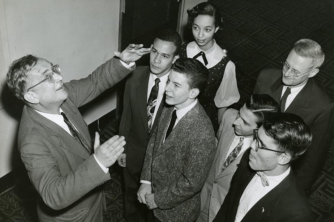 Black and white photo of Physicist George Gamow (left, with five GW students)