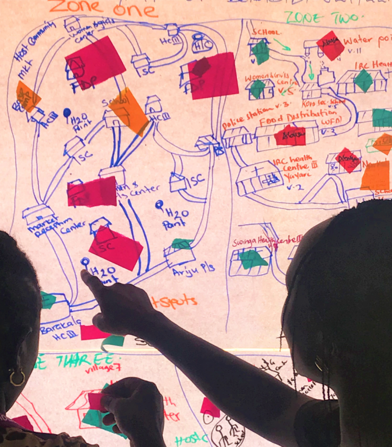 women pointing at a map